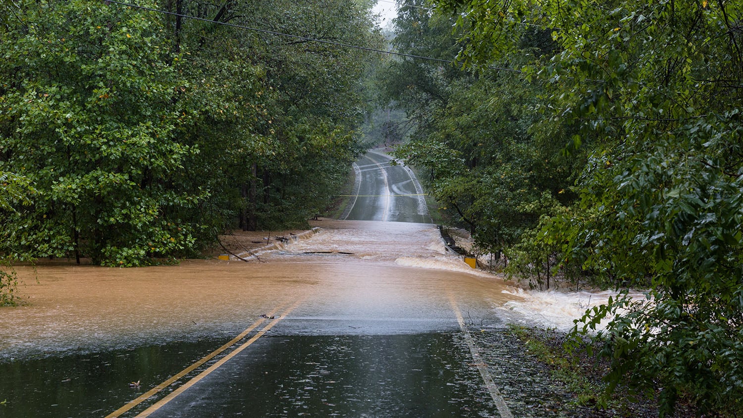 Rainwater from Hurricane Florence washes out a bridge